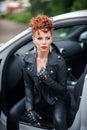 Beautiful young woman sitting in the white car with opened doors Royalty Free Stock Photo