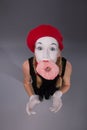 Portrait of pretty female mime eating a tasty pink Royalty Free Stock Photo