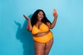 Portrait of pretty funky fat woman using device taking selfie posing blogging isolated over bright blue color background
