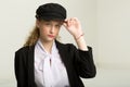 Portrait of pretty girl in black suit and cap Royalty Free Stock Photo