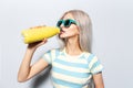 Portrait of pretty girl drinking water from thermo bottle on white background. Royalty Free Stock Photo