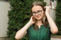 Portrait of cute young girl with eyeglasses, smiling. Blonde hair, natural, beautiful teen age girl. Summer portrait Royalty Free Stock Photo