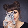 Portrait of a pretty girl with her cute blue-eyed cat Royalty Free Stock Photo