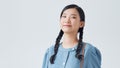 Portrait of a pretty girl holding backpack and looking at camera isolated over white background Royalty Free Stock Photo