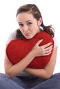 Portrait of a pretty girl hugging a big red heart Royalty Free Stock Photo