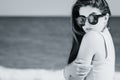 Portrait of a pretty girl with long hair in trendy sunglasses with palms reflection posing on the beach Royalty Free Stock Photo