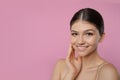Portrait of pretty girl on pink background, space for text. Beautiful face with perfect smooth skin Royalty Free Stock Photo
