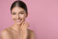 Portrait of pretty girl on pink background, space for text. Beautiful face with perfect smooth skin Royalty Free Stock Photo