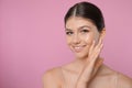 Portrait of pretty girl on pink background, space for text. Beautiful face with perfect smooth skin Royalty Free Stock Photo