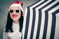 Portrait of a pretty girl in Santa Claus hat and sunglasses Royalty Free Stock Photo