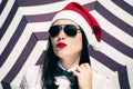 Portrait of a pretty girl in Santa Claus hat and sunglasses Royalty Free Stock Photo