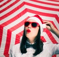 Portrait of a pretty girl in Santa Claus hat and sunglasses Royalty Free Stock Photo