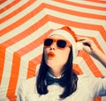 Portrait of a pretty girl in Santa Claus hat and sunglasses Royalty Free Stock Photo