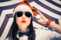 Portrait of a pretty girl in Santa Claus hat and sunglasses Royalty Free Stock Photo