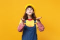 Portrait of pretty girl teenager in french beret, denim sundress blowing sending air kiss isolated on yellow wall Royalty Free Stock Photo