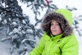 Portrait of pretty happy boy in winter snow park