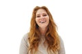 Portrait of pretty healthy beauty redhead woman with long healthy ginger curly hair laughing on white studio wall background Royalty Free Stock Photo