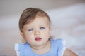 Portrait of pretty little baby girl in a blue dress at home Royalty Free Stock Photo