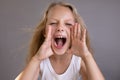 Portrait of a pretty little blonde girl showing emotions