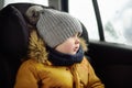 Portrait of pretty little boy sitting in car seat during roadtrip or travel Royalty Free Stock Photo