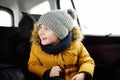 Portrait of pretty little boy sitting in car seat during roadtrip or travel Royalty Free Stock Photo