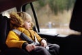 Portrait of pretty little boy sitting in car seat during roadtrip or travel Royalty Free Stock Photo