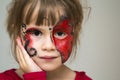 Portrait of pretty little girl with butterfly painting on her fa Royalty Free Stock Photo