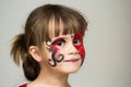 Portrait of pretty little girl with butterfly painting on her fa Royalty Free Stock Photo