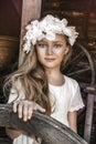 Portrait of pretty little girl. Fashion portrait of beautiful little girl with wreath and white dress. Spring fashion and Royalty Free Stock Photo