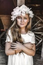 Portrait of pretty little girl. Fashion portrait of beautiful little girl with wreath and white dress. Spring fashion and Royalty Free Stock Photo