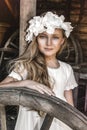 Portrait of pretty little girl. Fashion portrait of beautiful little girl with wreath and white dress. Spring fashion and Royalty Free Stock Photo