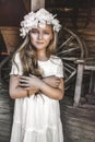 Portrait of pretty little girl. Fashion portrait of beautiful little girl with wreath and white dress. Spring fashion and Royalty Free Stock Photo