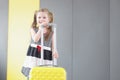 Pretty little girl going on vacation, packed stuff in yellow suitcase, kid in lovely summer dress