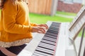 Portrait of pretty little girl having piano lesson at modern white e-piano Royalty Free Stock Photo