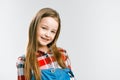 Portrait of a pretty little girl in jeans and a plaid shirt. studio fashion photography. Royalty Free Stock Photo