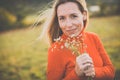 Portrait of a pretty middle-aged  woman outside in a park, picking flowers Royalty Free Stock Photo