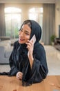 Portrait of pretty middle eastern arab woman talking on mobile phone at her luxury apartment. Royalty Free Stock Photo