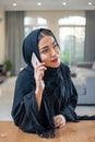 Portrait of pretty middle eastern arab woman talking on mobile phone at home Royalty Free Stock Photo