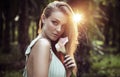 Portrait of a pretty, natural lady holding a flower Royalty Free Stock Photo