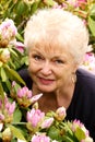 Portrait of a Pretty Older Lady in Her Flowers Royalty Free Stock Photo