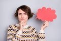 Portrait of pretty pensive sullen girl holding in hand paper cloud shape overthinking isolated over grey pastel color