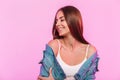 Portrait pretty positive young woman with cute smile in blue vintage denim jacket in fashionable t-shirt near pink wall in the Royalty Free Stock Photo