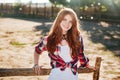 Portrait of pretty redhead cowgirl leaning on the ranch fence Royalty Free Stock Photo