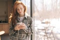 Portrait of pretty redhead young woman feeling happy using mobile phone communicate with family enjoy life in house Royalty Free Stock Photo