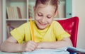 Portrait of pretty school girl are studying at classroom at the table