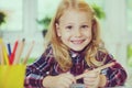 Portrait of pretty school girl are studying at classroom at the table