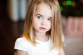 Portrait of a pretty serious girls baby blonde with straight hair,looking to the side , close up Royalty Free Stock Photo