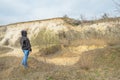 Portrait of pretty slim woman standing in front of sand quarry, freedom