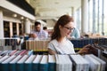 Portrait of a pretty smiling girl reading book in library Royalty Free Stock Photo