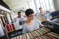 Portrait of a pretty smiling girl reading book in library Royalty Free Stock Photo